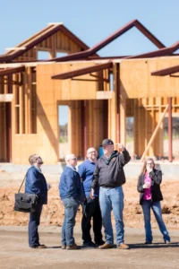 mccaffrey-team-in-front-of-new-construction-homes